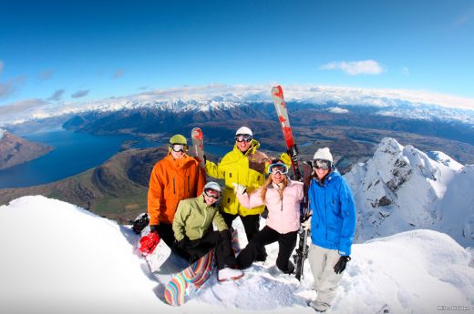 A Group Of People Standing On Top Of A Snow Covered Mountain